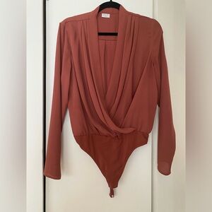Babaton size M bodysuit. Rust color. Plunging neckline. Snap closure